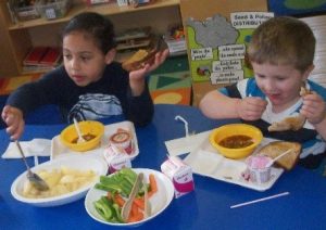 One of the submissions from the CACFP photo contest highlights children practicing family style dining and having a healthy celebration.